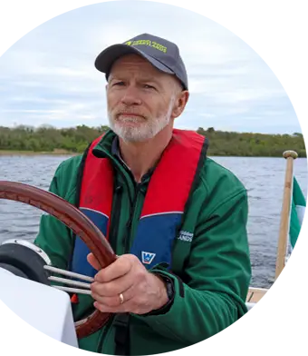 John Sorohan at the wheel of his boat